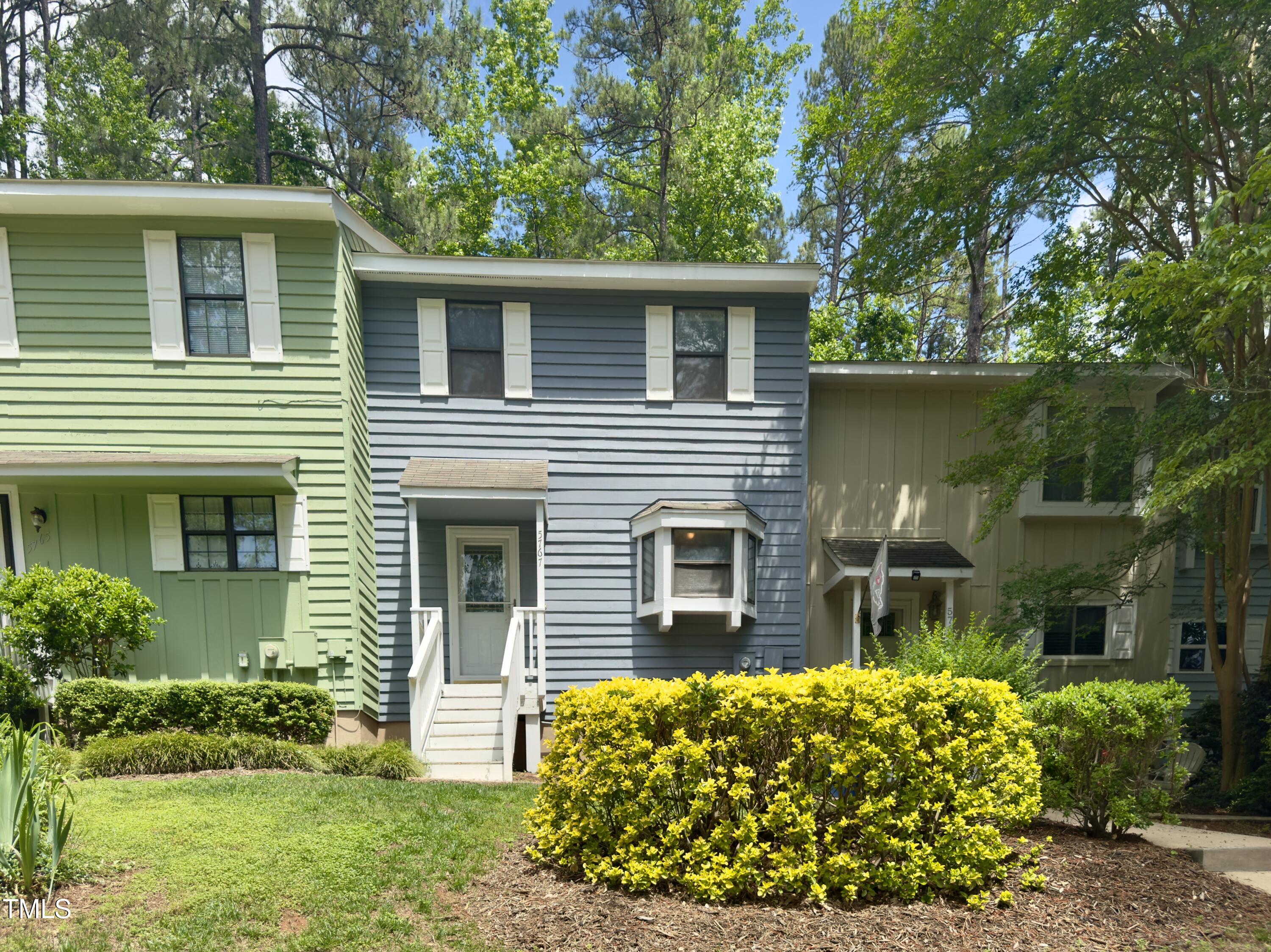 5767 Forest Lawn Court Raleigh, NC 27612 - Photo 1 of 17 a front view of a house with garden