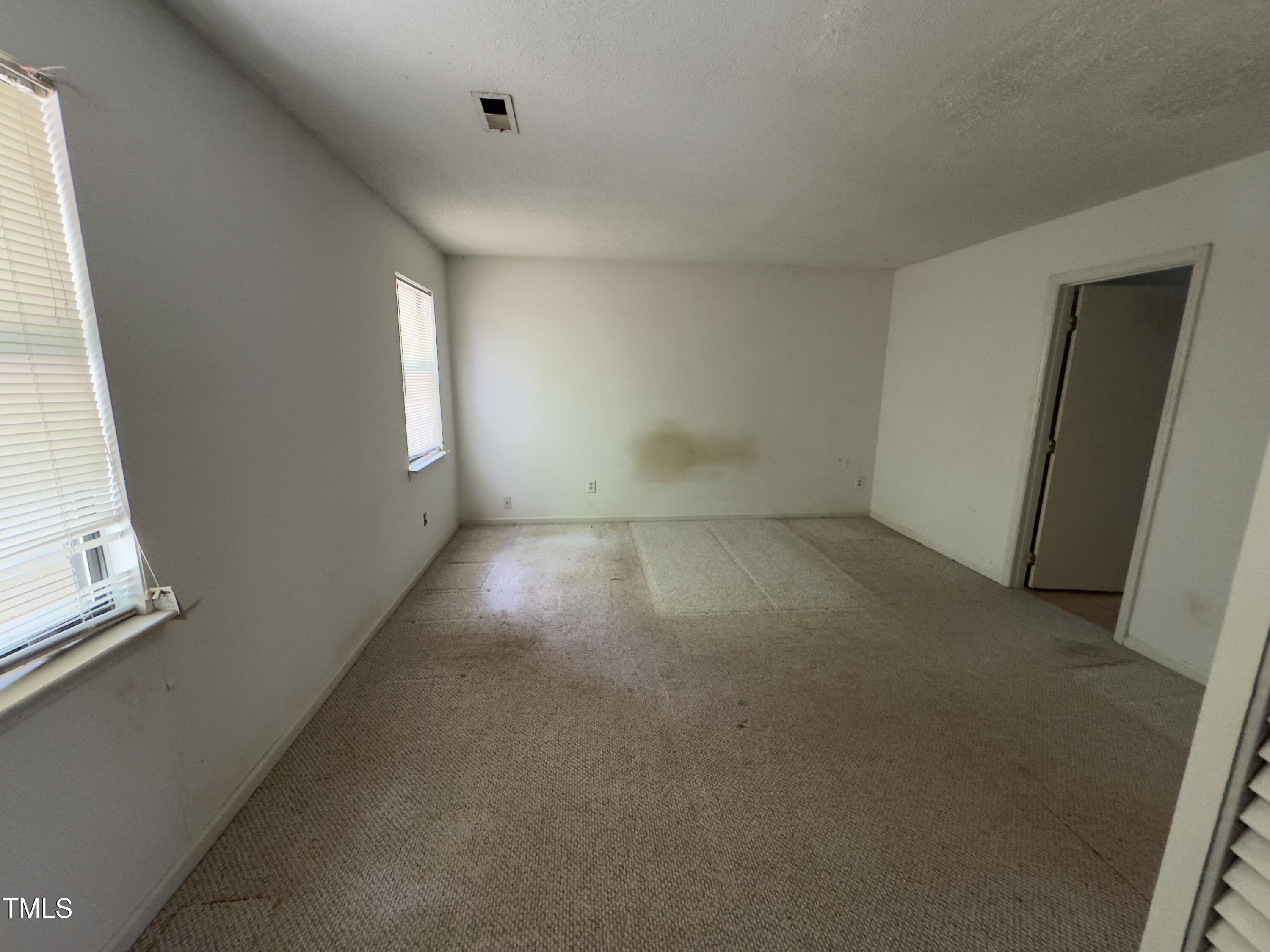 5767 Forest Lawn Court Raleigh, NC 27612 - Photo 8 of 17 an empty room with windows
