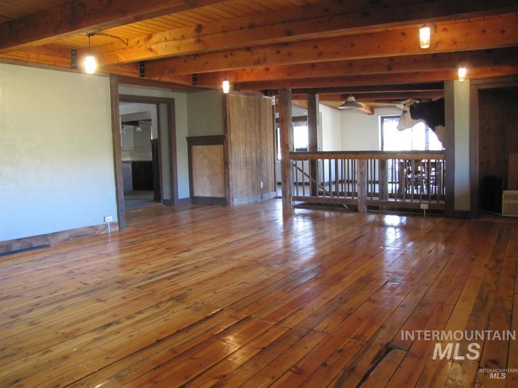 11500 Brownlee Road Sweet, ID 83670 - Photo 7 of 22 Unfurnished living room featuring wood-type flooring and a wooden ceiling with exposed beams