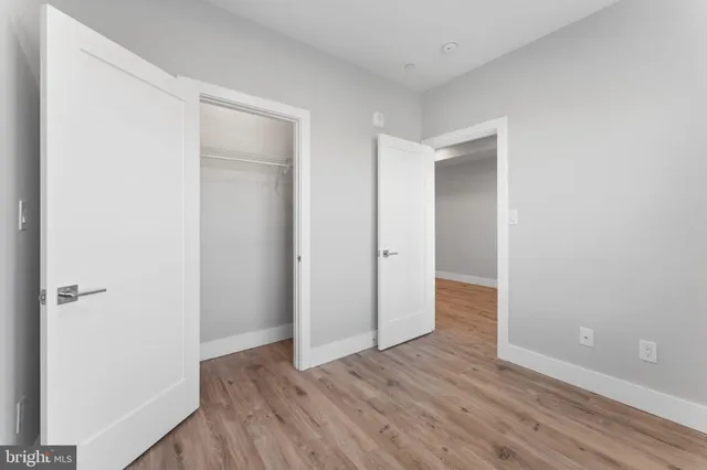 a view of hallway with wooden floor