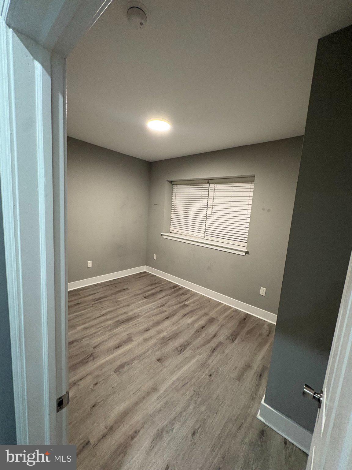 1813 South 23rd Street, Unit 2 Philadelphia, PA 19145 - Photo 11 of 20 an empty room with wooden floor and windows