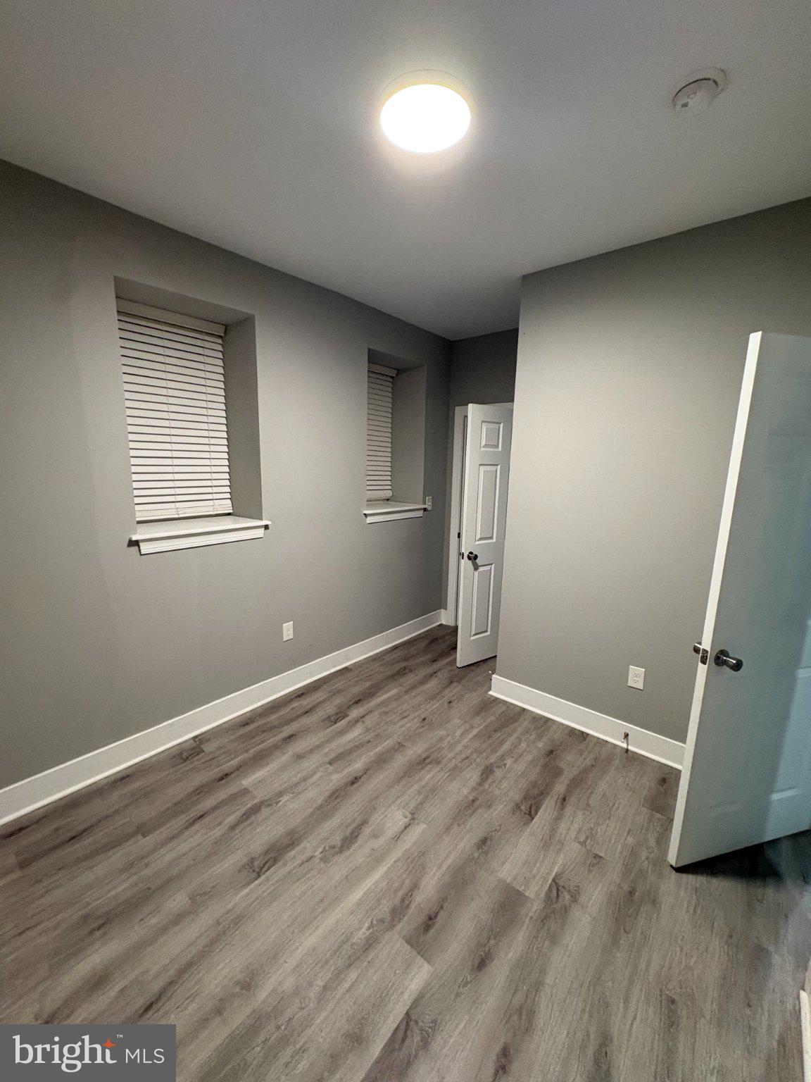 1813 South 23rd Street, Unit 2 Philadelphia, PA 19145 - Photo 13 of 20 an empty room with wooden floor and windows