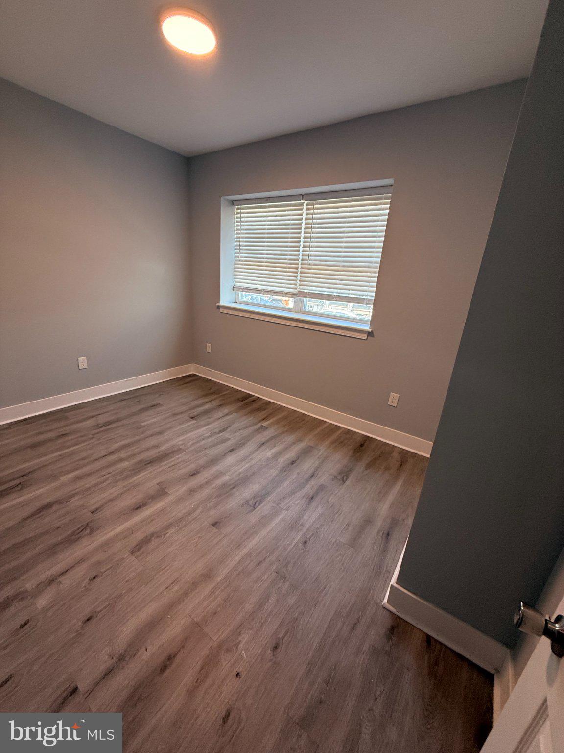 1813 South 23rd Street, Unit 2 Philadelphia, PA 19145 - Photo 15 of 20 an empty room with wooden floor and windows