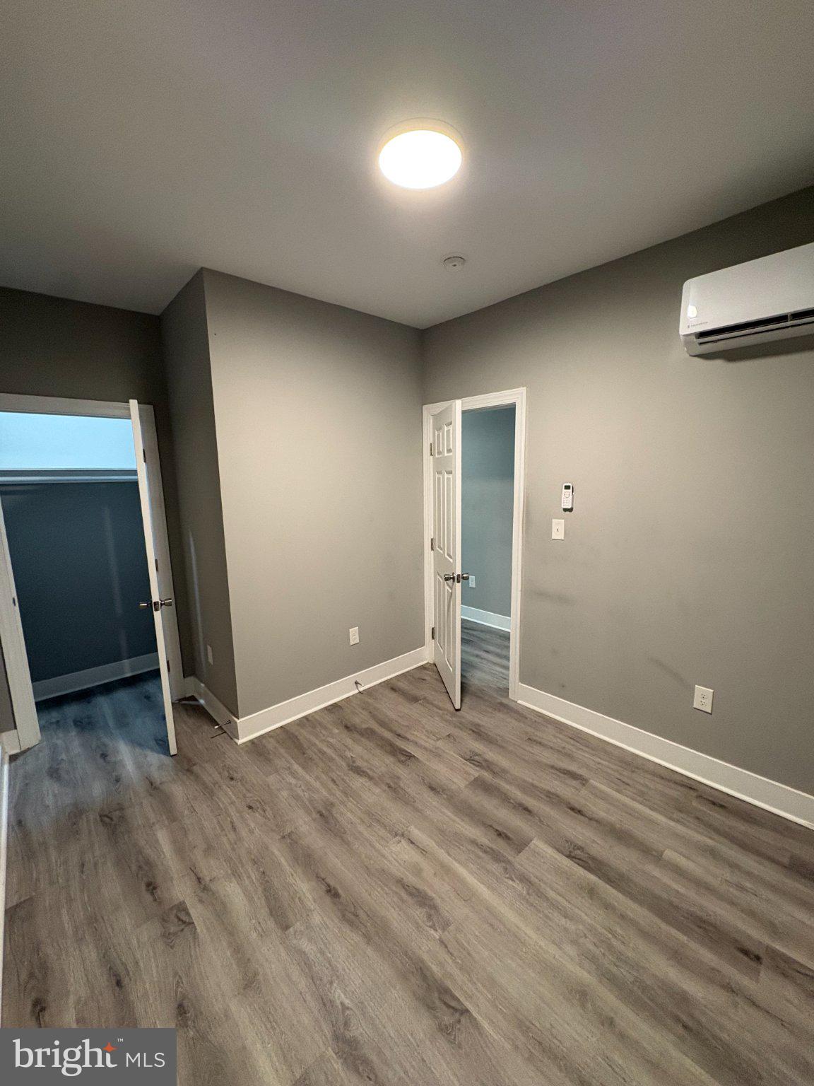 1813 South 23rd Street, Unit 2 Philadelphia, PA 19145 - Photo 16 of 20 an empty room with wooden floor and windows
