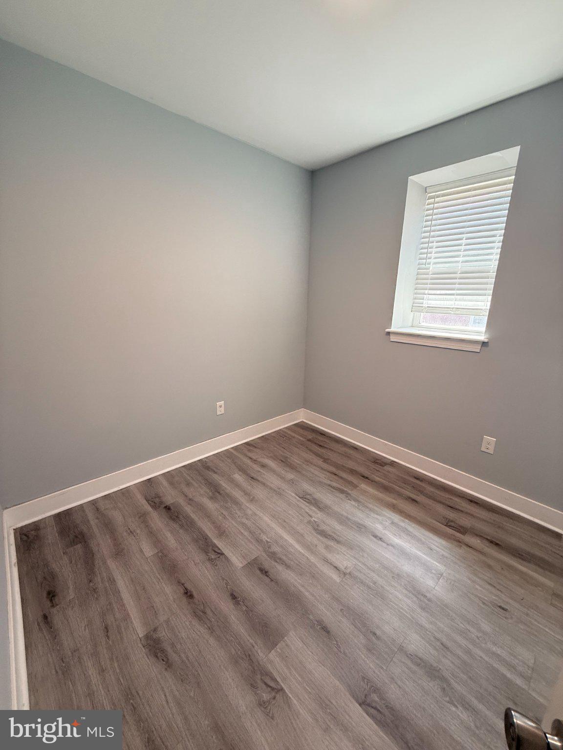 1813 South 23rd Street, Unit 2 Philadelphia, PA 19145 - Photo 17 of 20 a view of an empty room with wooden floor and a window