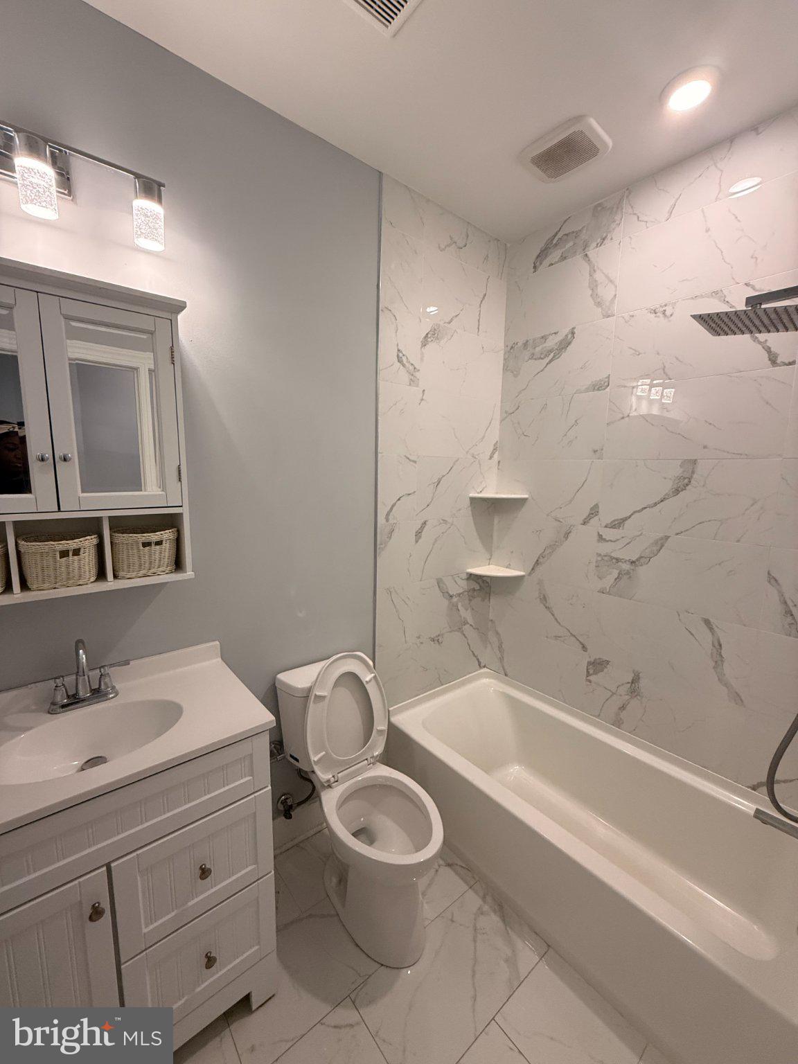 1813 South 23rd Street, Unit 2 Philadelphia, PA 19145 - Photo 6 of 20 a bathroom with a granite countertop toilet a sink and bathtub