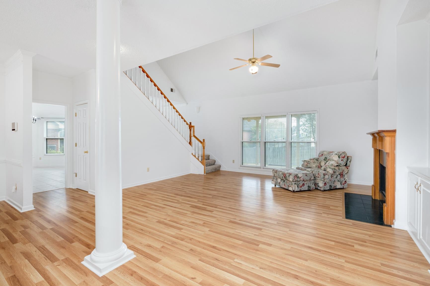 9015 Raspberry Lane Cordova, TN 38016 - Photo 9 of 40 Unfurnished living room featuring high vaulted ceiling, light wood-type flooring, ceiling fan, and decorative columns