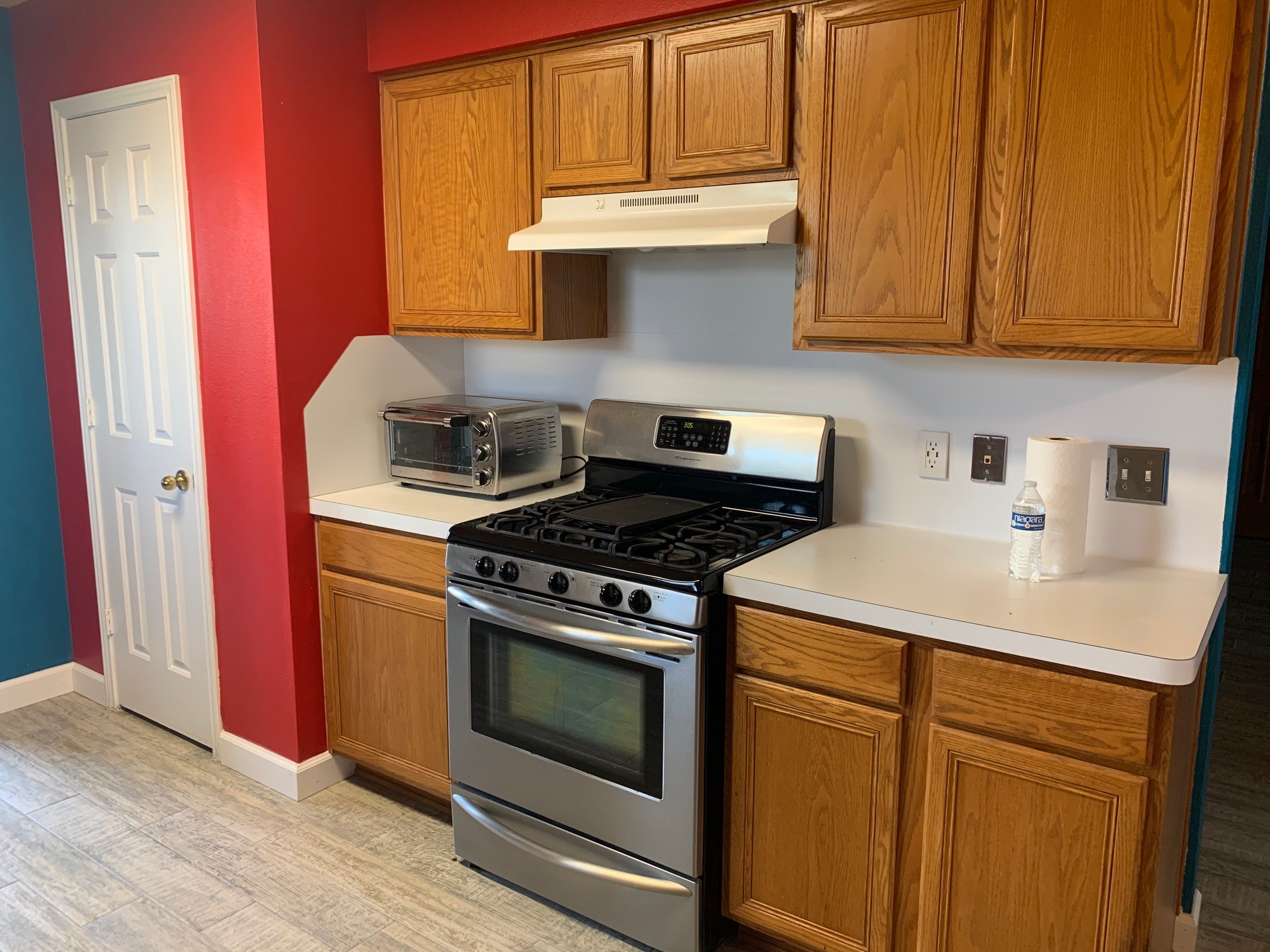 13605 Ralph Ritchie Road Manor, TX 78653 - Photo 11 of 19 Kitchen featuring stainless steel gas range oven, wood finish cabinetry, and light countertops