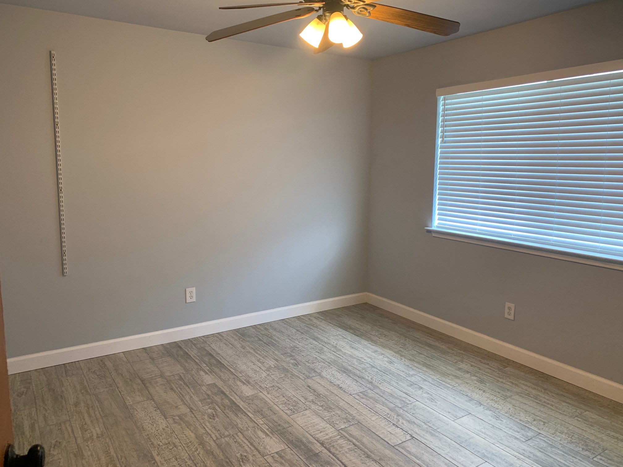 13605 Ralph Ritchie Road Manor, TX 78653 - Photo 15 of 19 Empty room with a ceiling fan and light wood-style floors