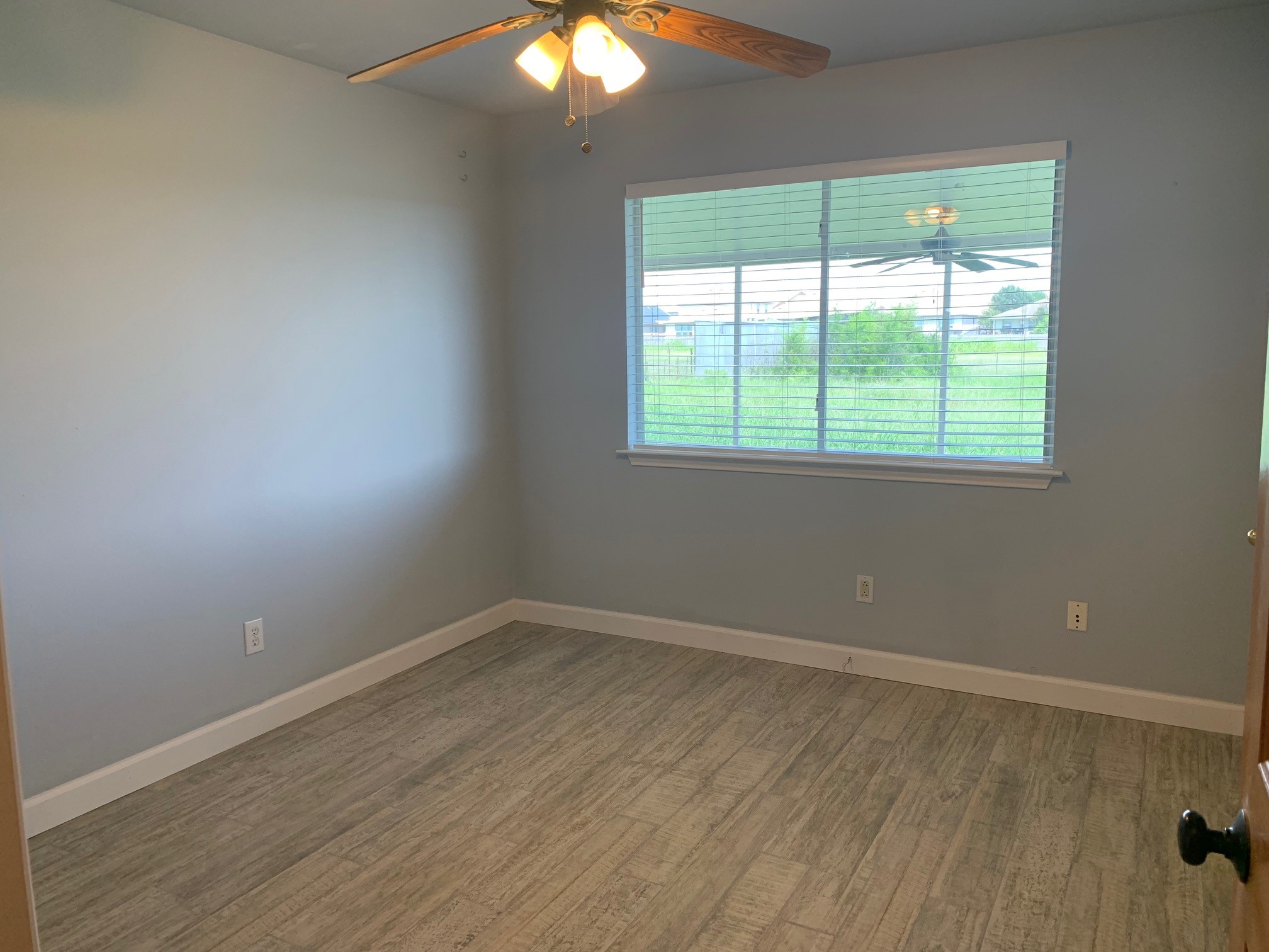 13605 Ralph Ritchie Road Manor, TX 78653 - Photo 16 of 19 Empty room featuring a ceiling fan and light wood finished floors