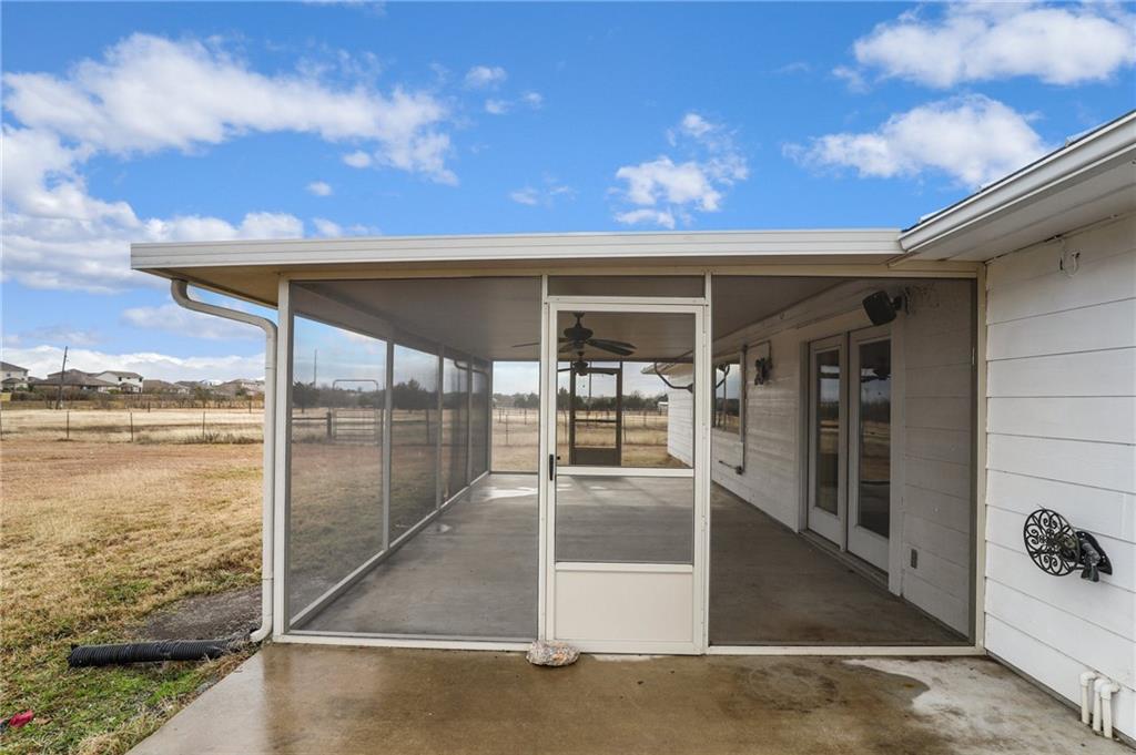 13605 Ralph Ritchie Road Manor, TX 78653 - Photo 7 of 19 View of patio with a ceiling fan and a sunroom