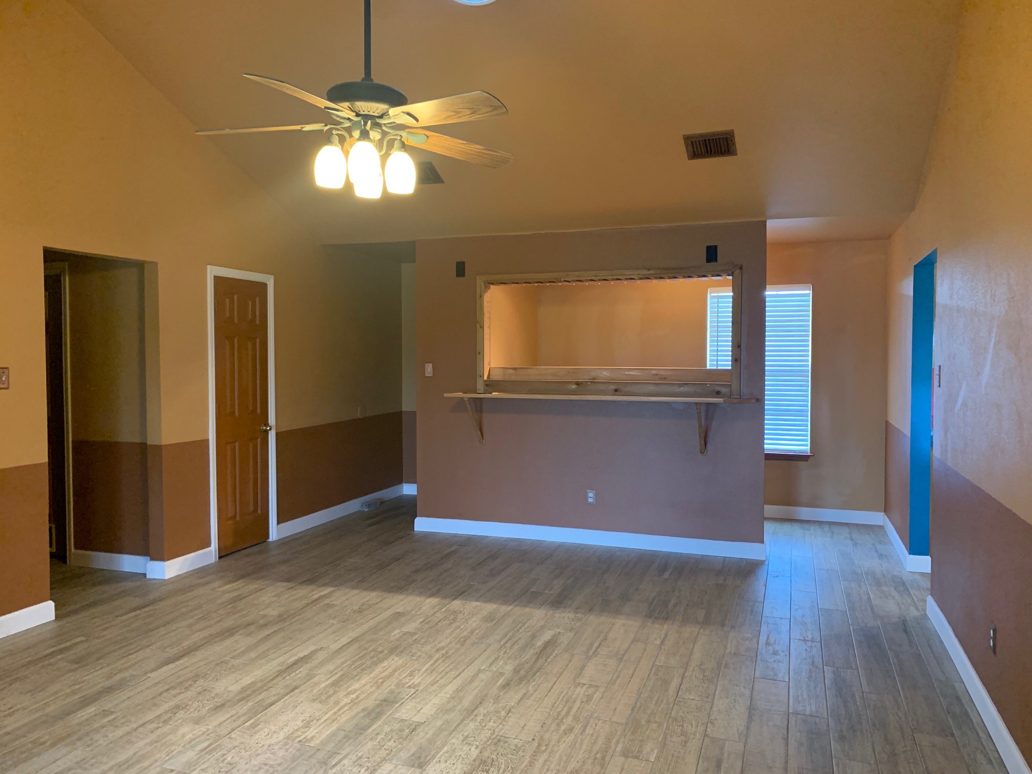 13605 Ralph Ritchie Road Manor, TX 78653 - Photo 9 of 19 Unfurnished living room featuring lofted ceiling, wood finished floors, and ceiling fan