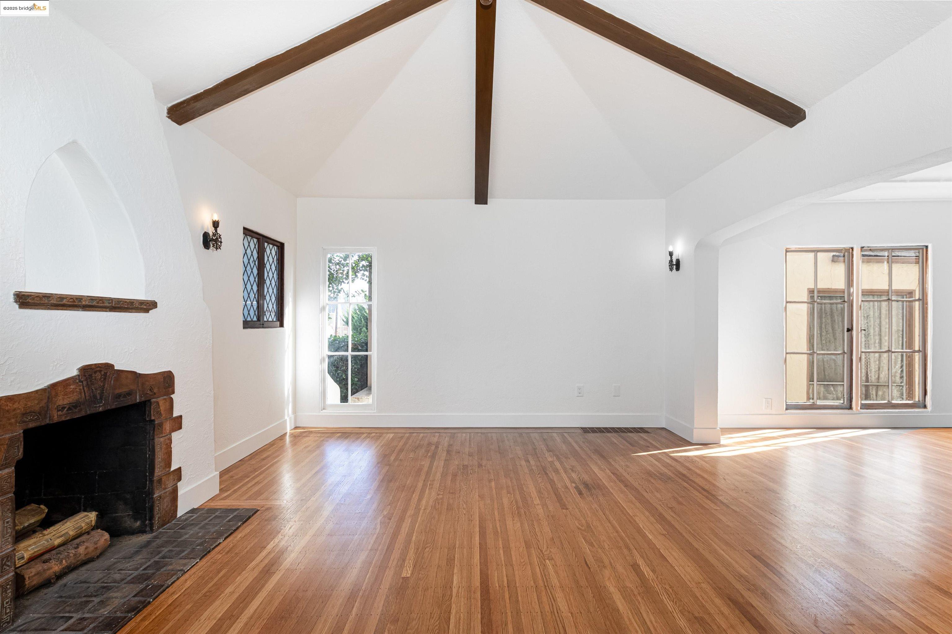 7601 Holly Street Oakland, CA 94621 - Photo 11 of 51 a view of an empty room with wooden floor and a window