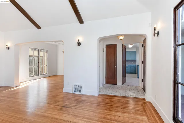 a view of a hallway with wooden floor and staircase