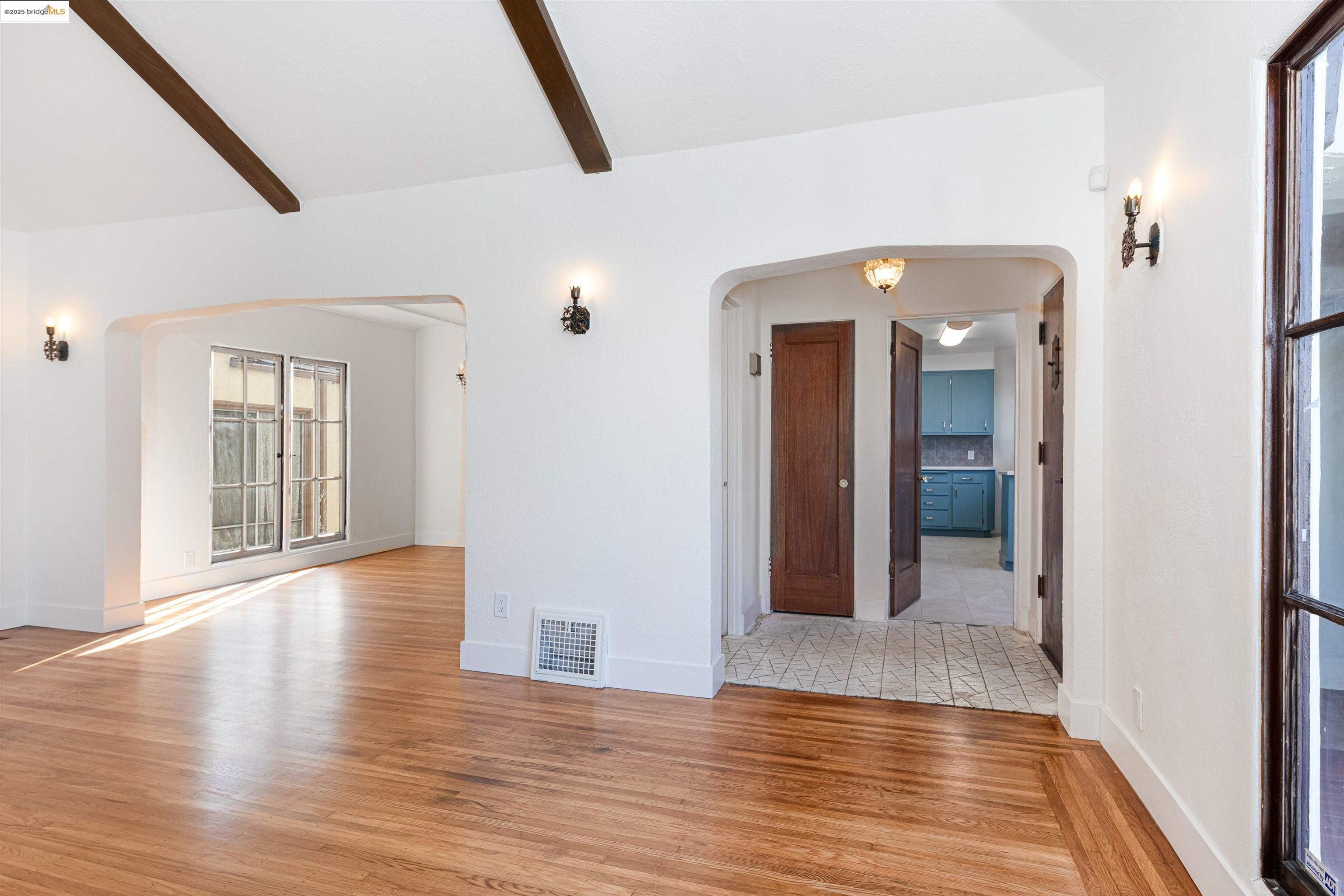 7601 Holly Street Oakland, CA 94621 - Photo 12 of 51 a view of a hallway with wooden floor and staircase