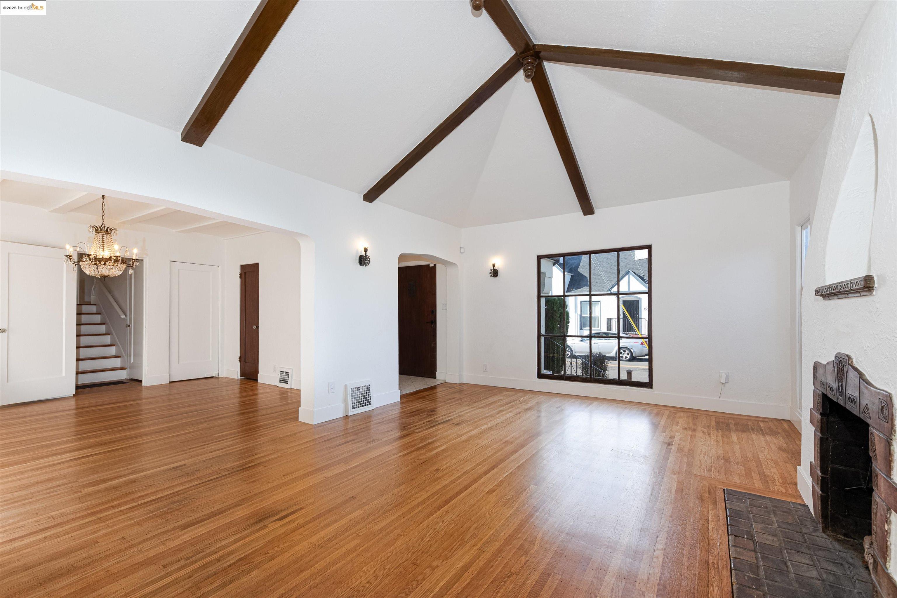 7601 Holly Street Oakland, CA 94621 - Photo 13 of 51 a view of an empty room with wooden floor and a window