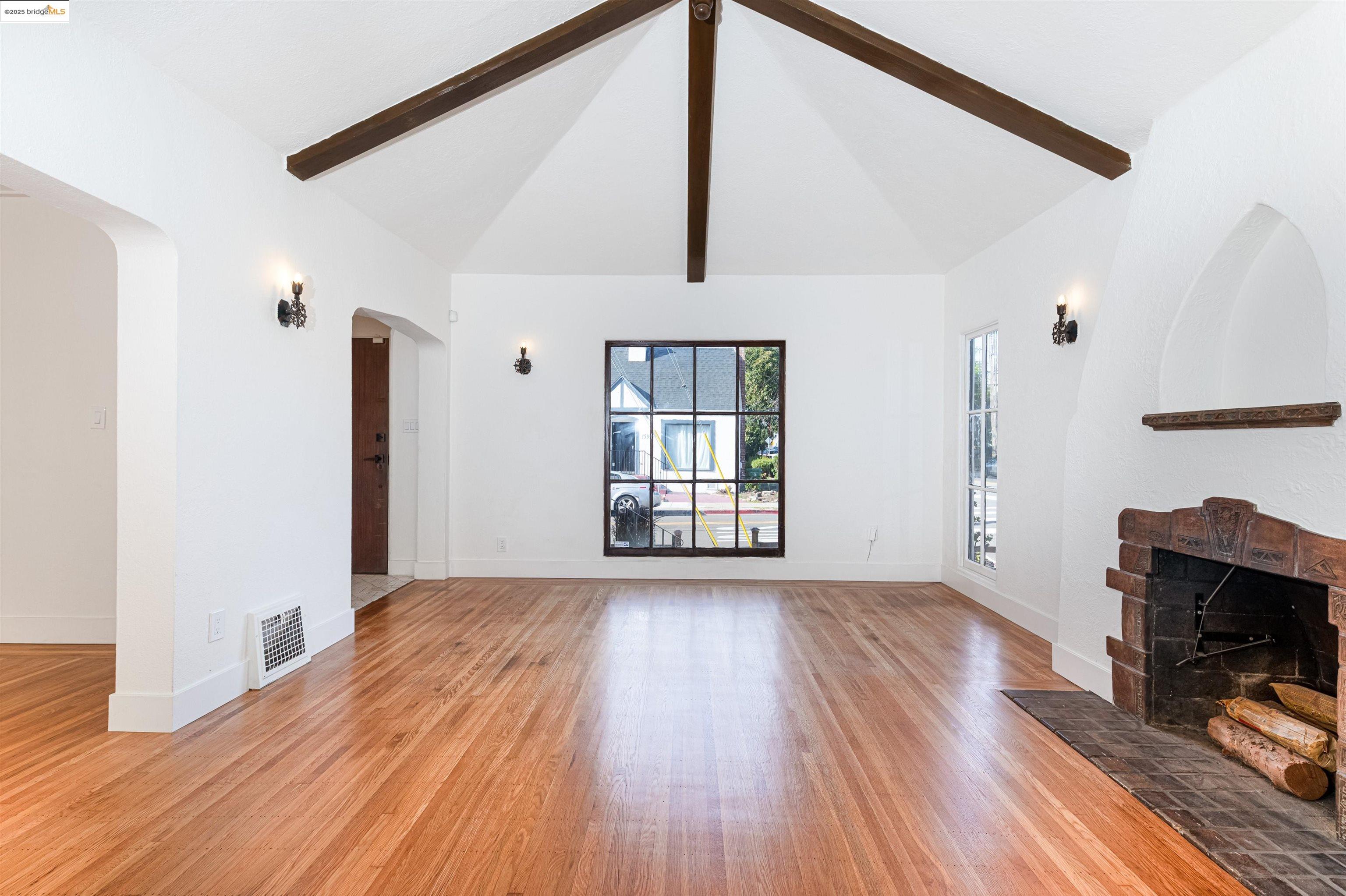 7601 Holly Street Oakland, CA 94621 - Photo 14 of 51 a view of empty room with wooden floor and fan