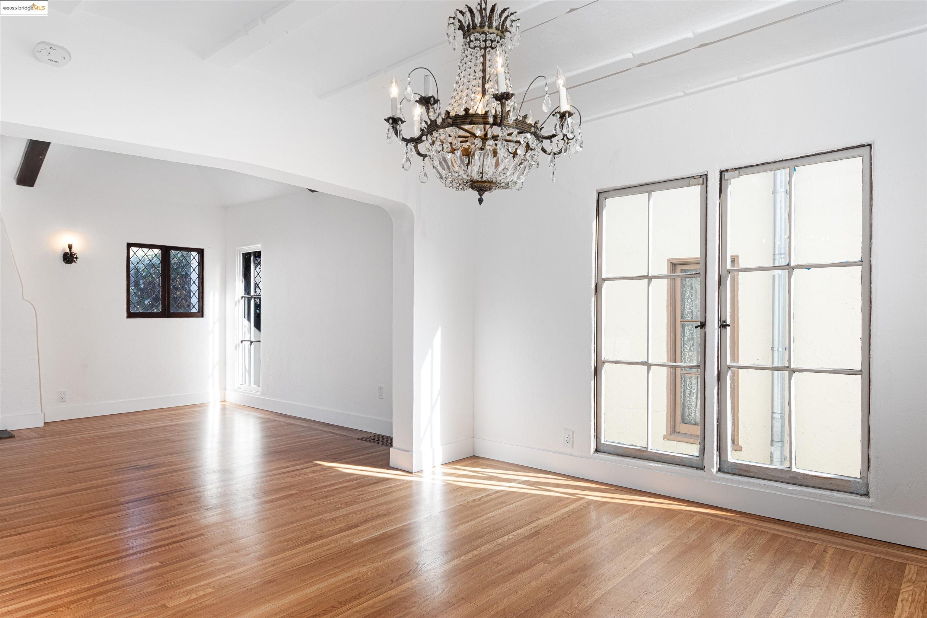 7601 Holly Street Oakland, CA 94621 - Photo 17 of 51 a view of an empty room with wooden floor and a window