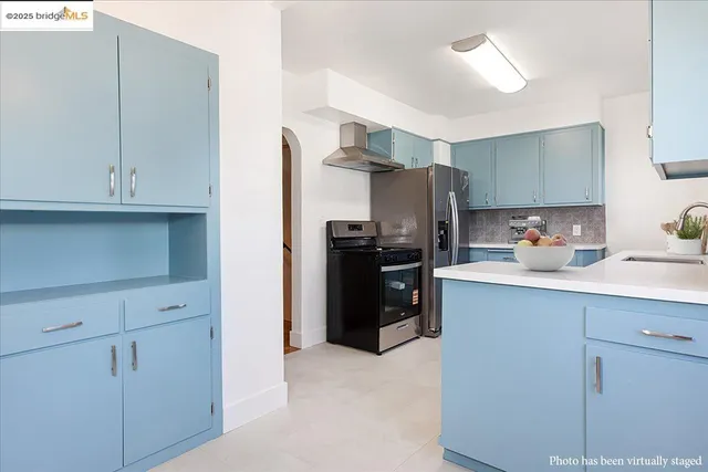 a kitchen with stainless steel appliances a refrigerator and cabinets