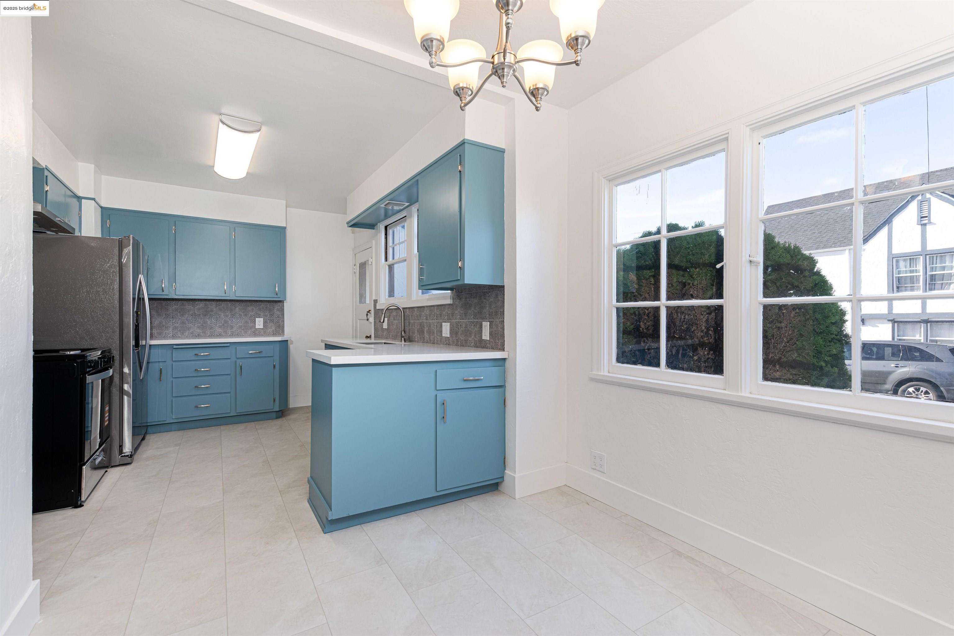 7601 Holly Street Oakland, CA 94621 - Photo 24 of 51 a kitchen with stainless steel appliances a sink stove and refrigerator