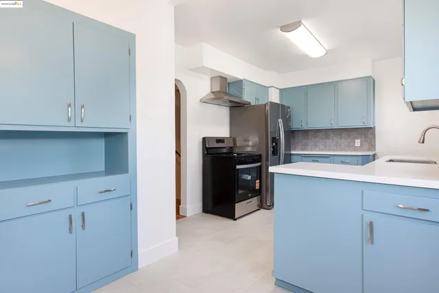 a kitchen with a sink stove and cabinets