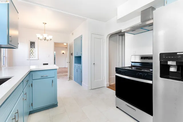 a kitchen with a sink window and cabinets