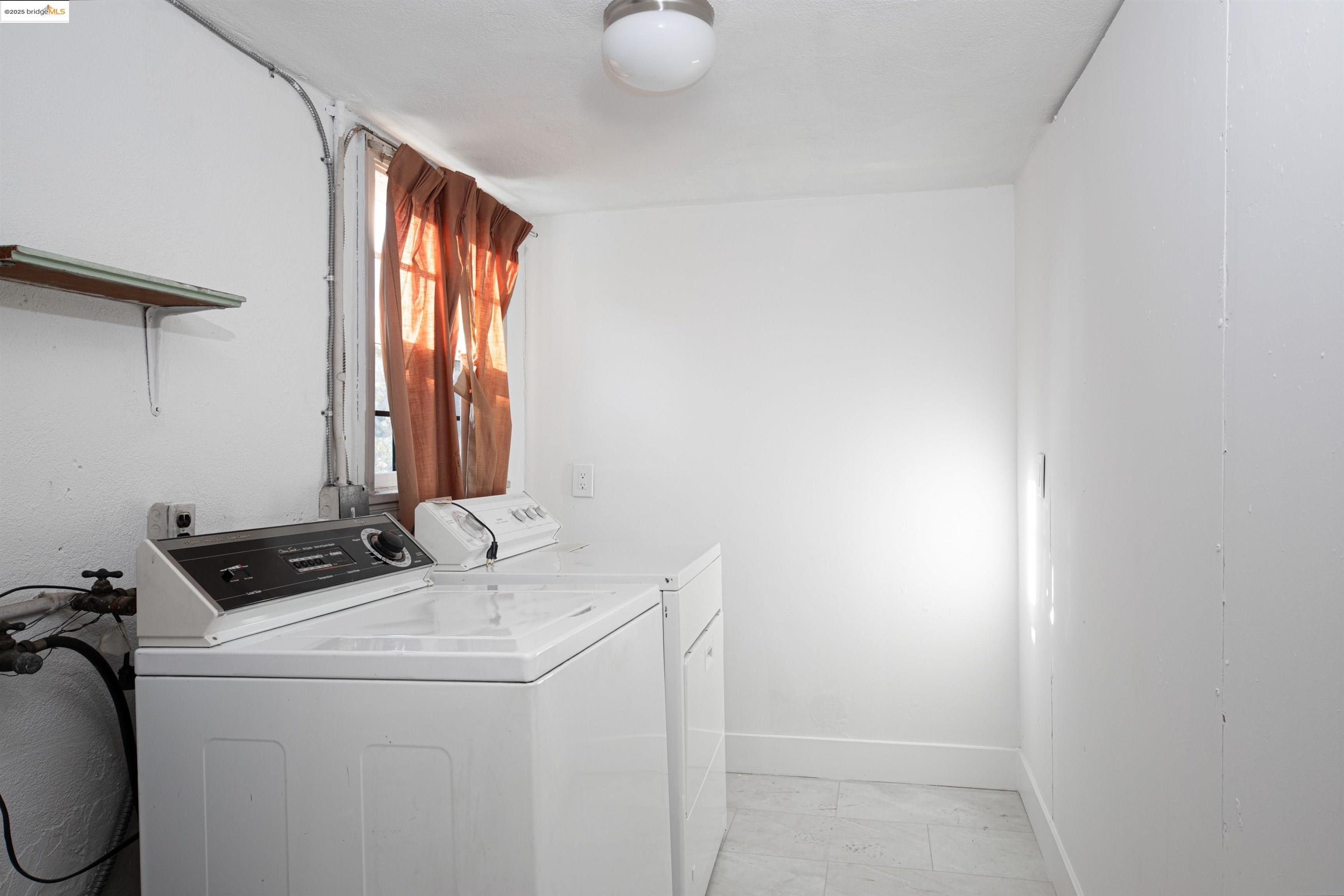 7601 Holly Street Oakland, CA 94621 - Photo 45 of 51 a utility room with dryer and washer
