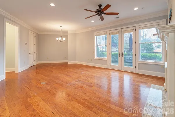 a view of a livingroom with a furniture wooden floor and a ceiling fan