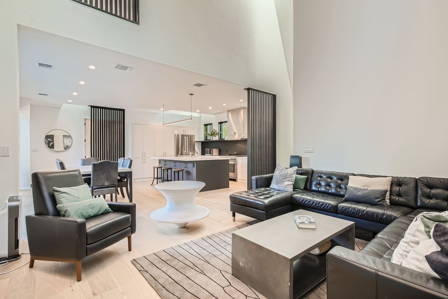 7525 Delafield Lane, Unit A Austin, TX 78752 - Photo 7 of 33 Living room featuring a high ceiling and recessed lighting