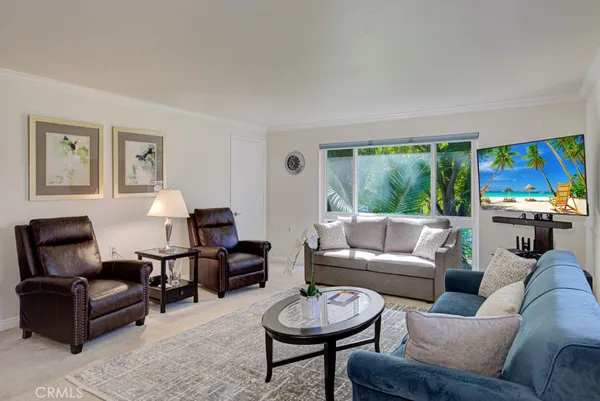 a living room with furniture a rug and a large window