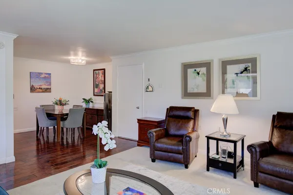 a living room with furniture a piano and a lamp