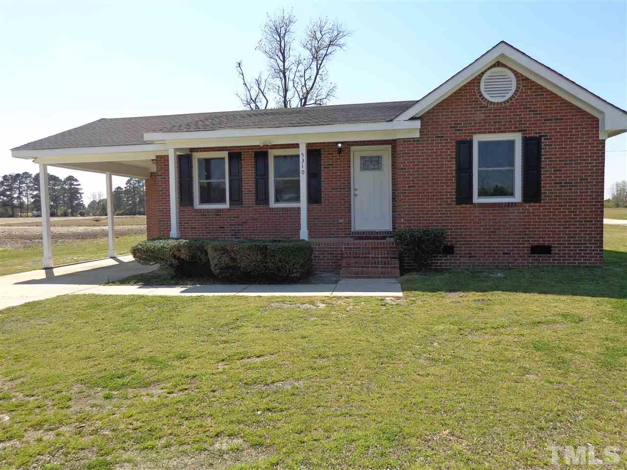 5310 Fairground Road Dunn, NC 28334 - Photo 1 of 13 a front view of a house with garden