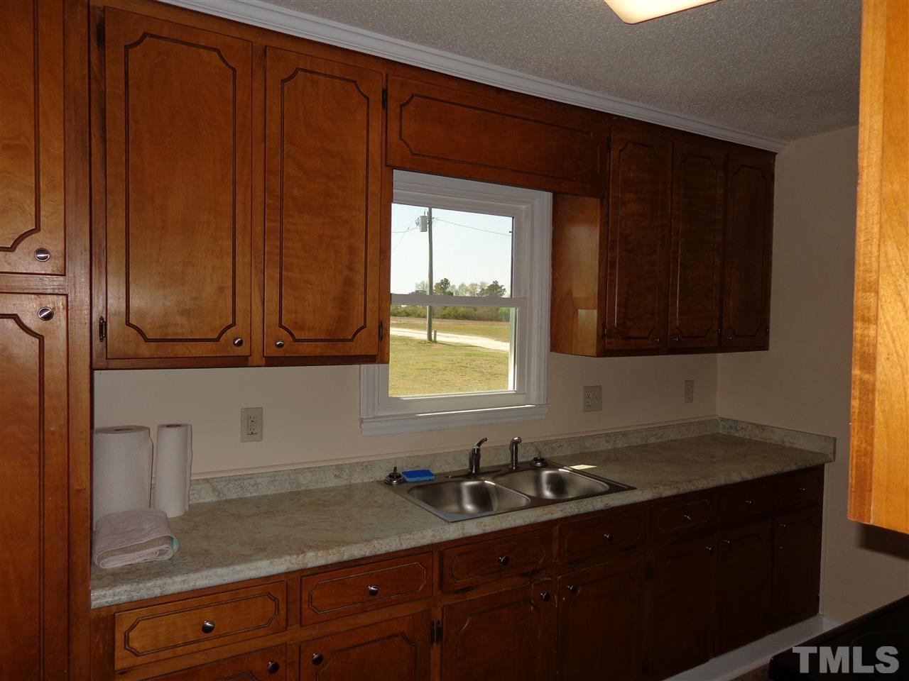 5310 Fairground Road Dunn, NC 28334 - Photo 2 of 13 a kitchen with sink window and cabinets