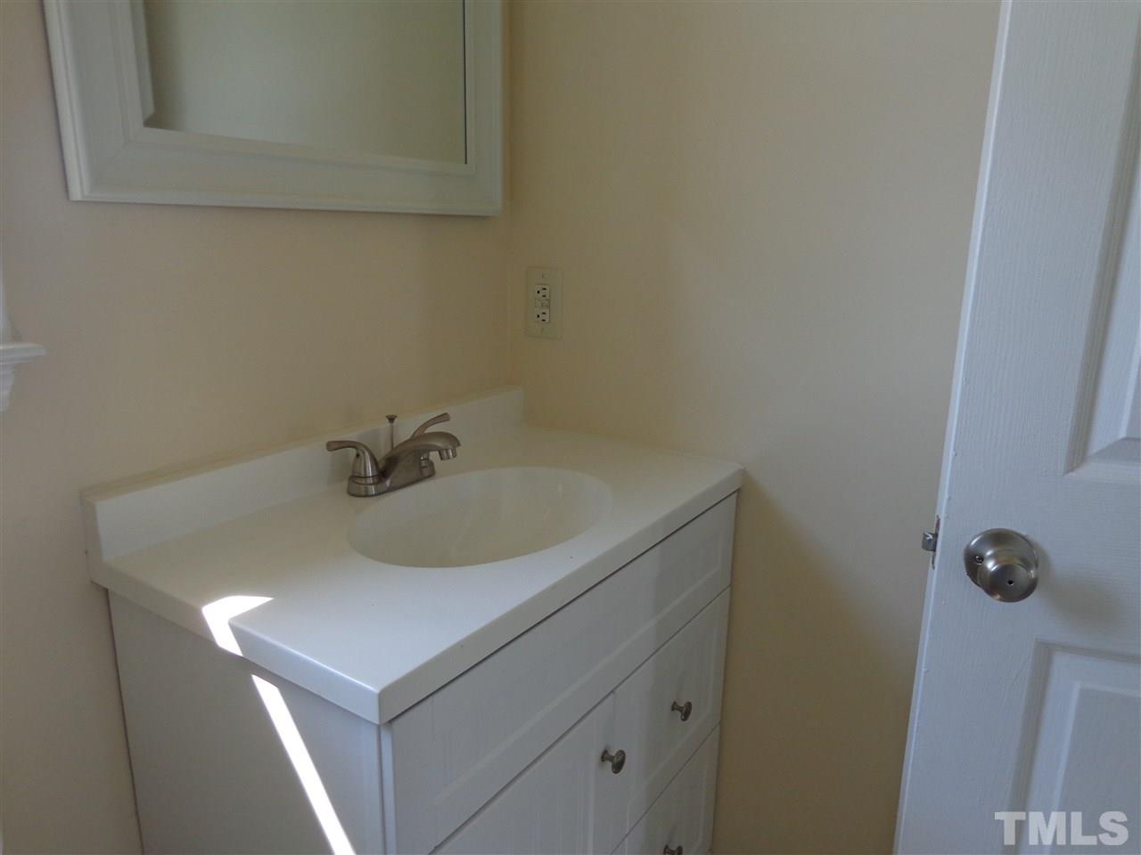 5310 Fairground Road Dunn, NC 28334 - Photo 12 of 13 a bathroom with a sink and cabinets