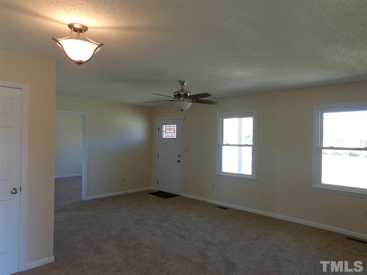 5310 Fairground Road Dunn, NC 28334 - Photo 3 of 13 an empty room with windows and fan