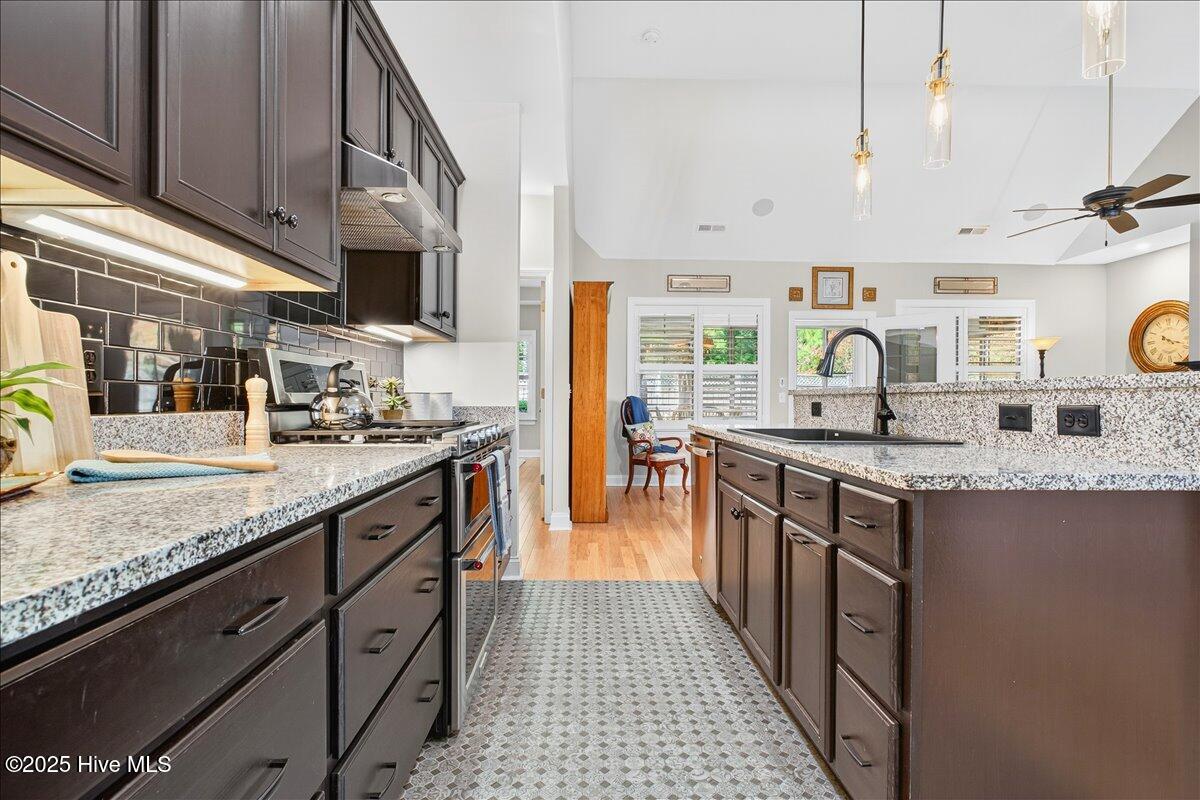 4173 Cambridge Cove Road, Unit 2 Southport, NC 28461 - Photo 10 of 66 Beautiful granite countertops, backsplash, and tile floor in kitchen