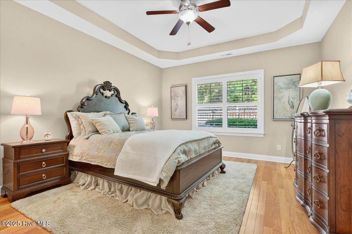 4173 Cambridge Cove Road, Unit 2 Southport, NC 28461 - Photo 28 of 66 Luxurious primary bedroom with tray ceiling