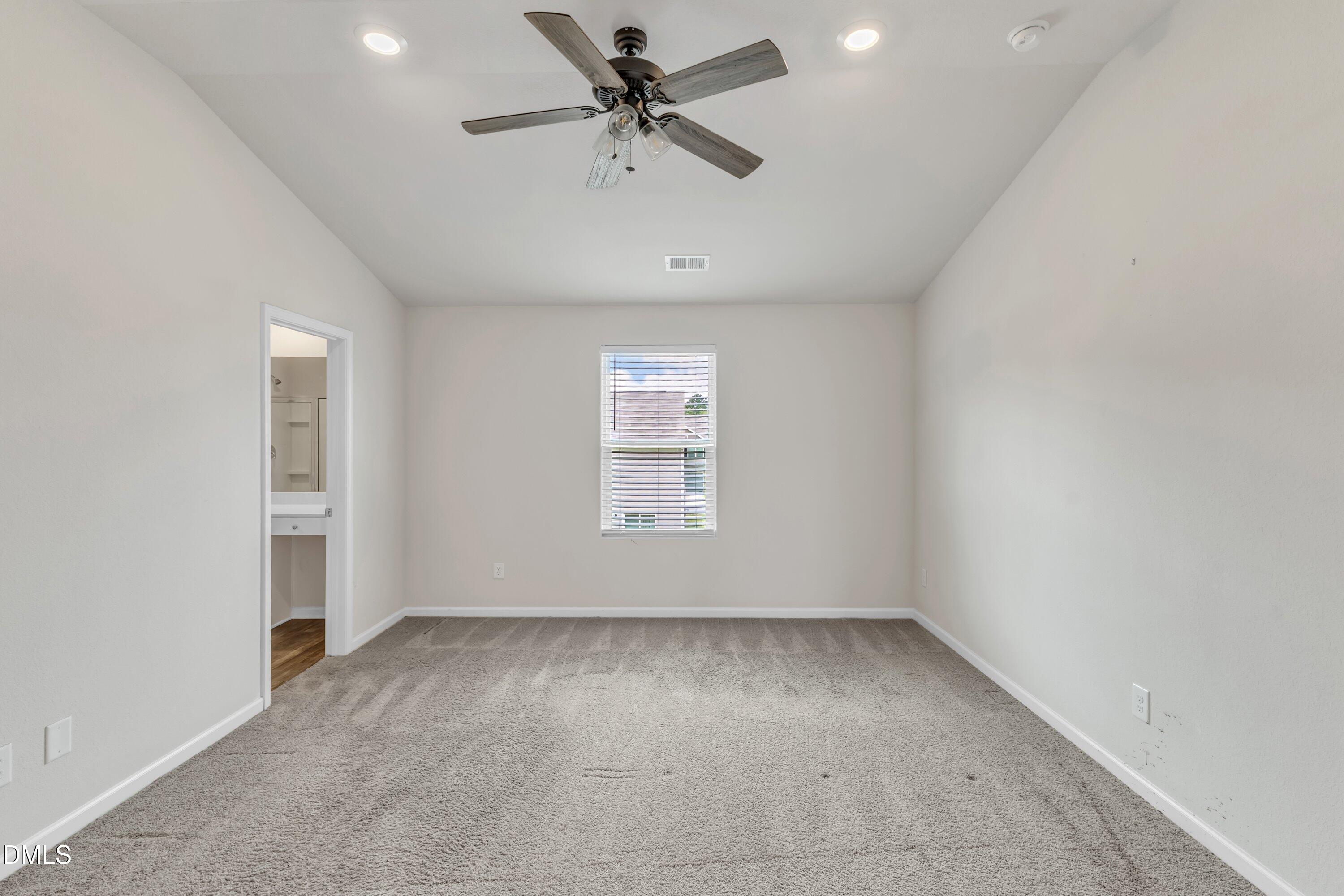 717 Little Patch Street Zebulon, NC 27597 - Photo 23 of 36 an empty room with a ceiling fan and window