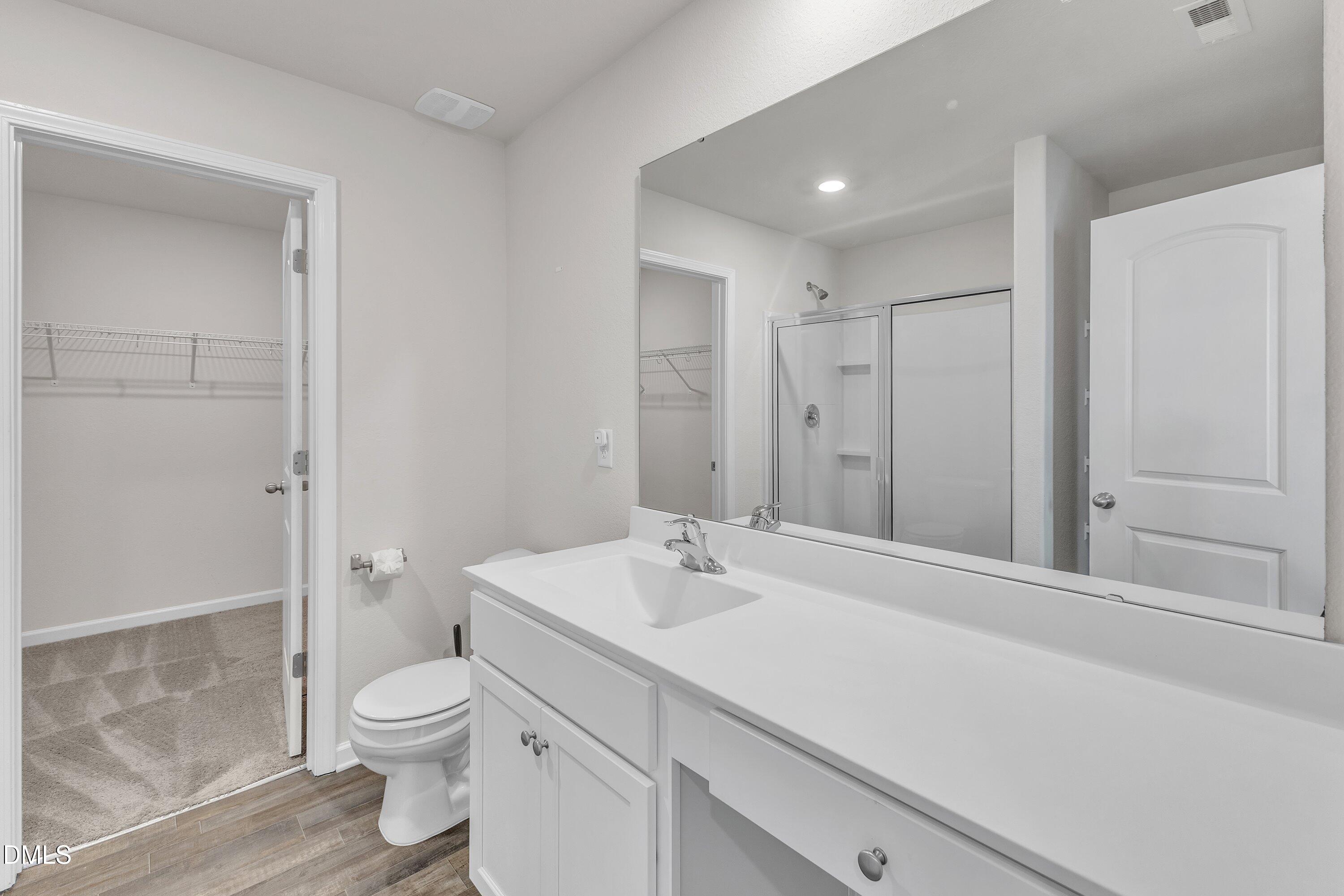717 Little Patch Street Zebulon, NC 27597 - Photo 26 of 36 a bathroom with a sink a toilet and shower