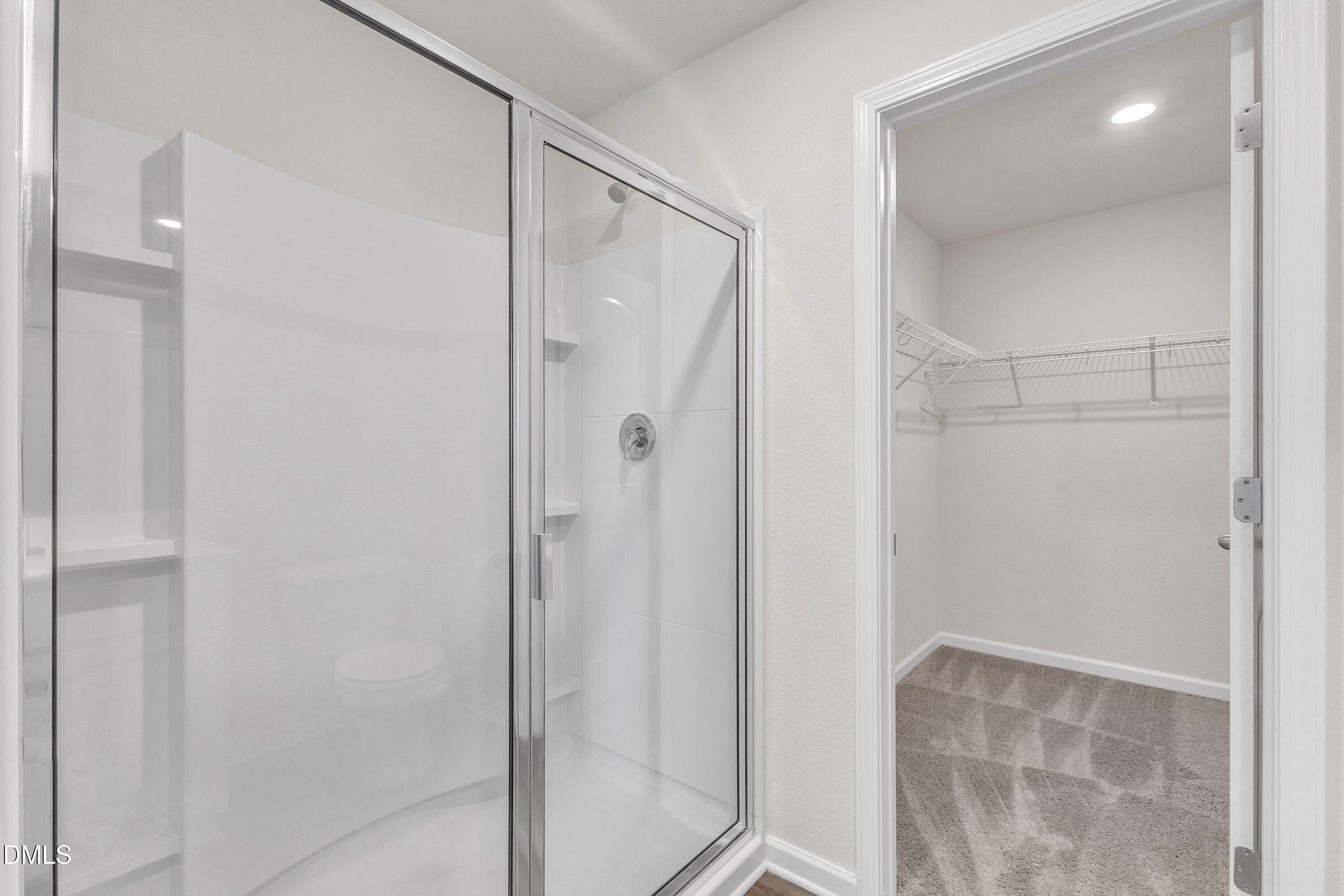 717 Little Patch Street Zebulon, NC 27597 - Photo 27 of 36 a bathroom with a glass shower door