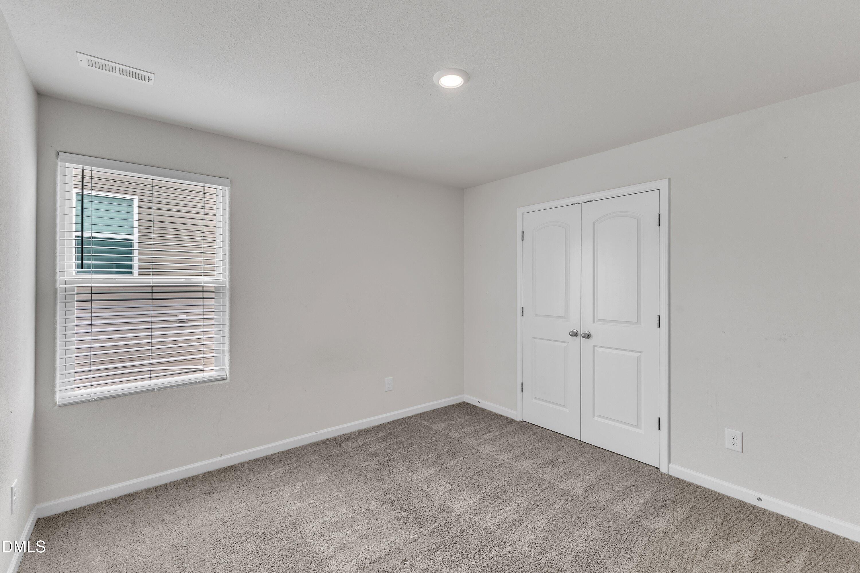 717 Little Patch Street Zebulon, NC 27597 - Photo 30 of 36 a view of an empty room with a window
