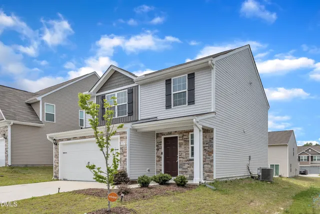 a front view of a house with a yard