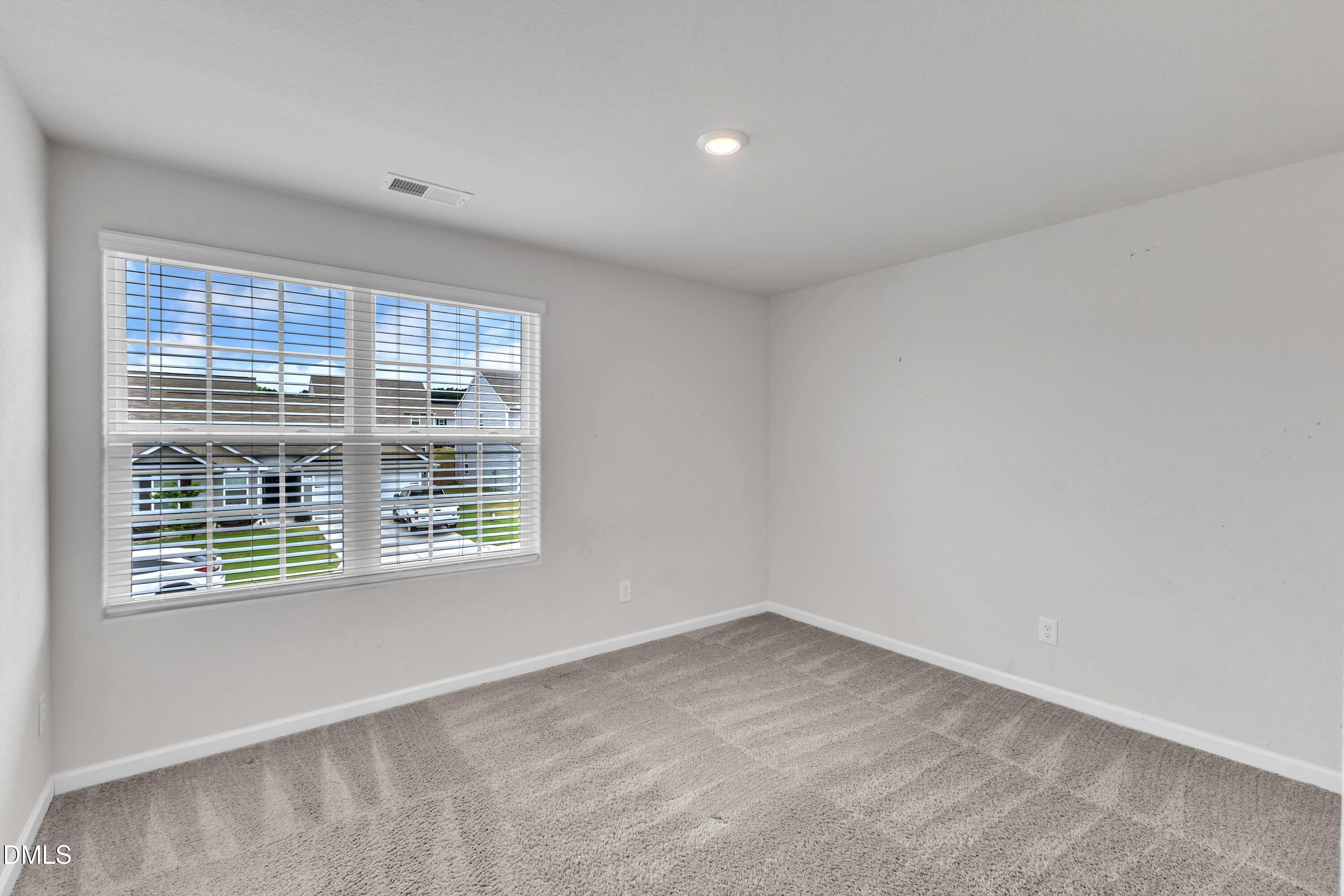 717 Little Patch Street Zebulon, NC 27597 - Photo 32 of 36 an empty room with a window