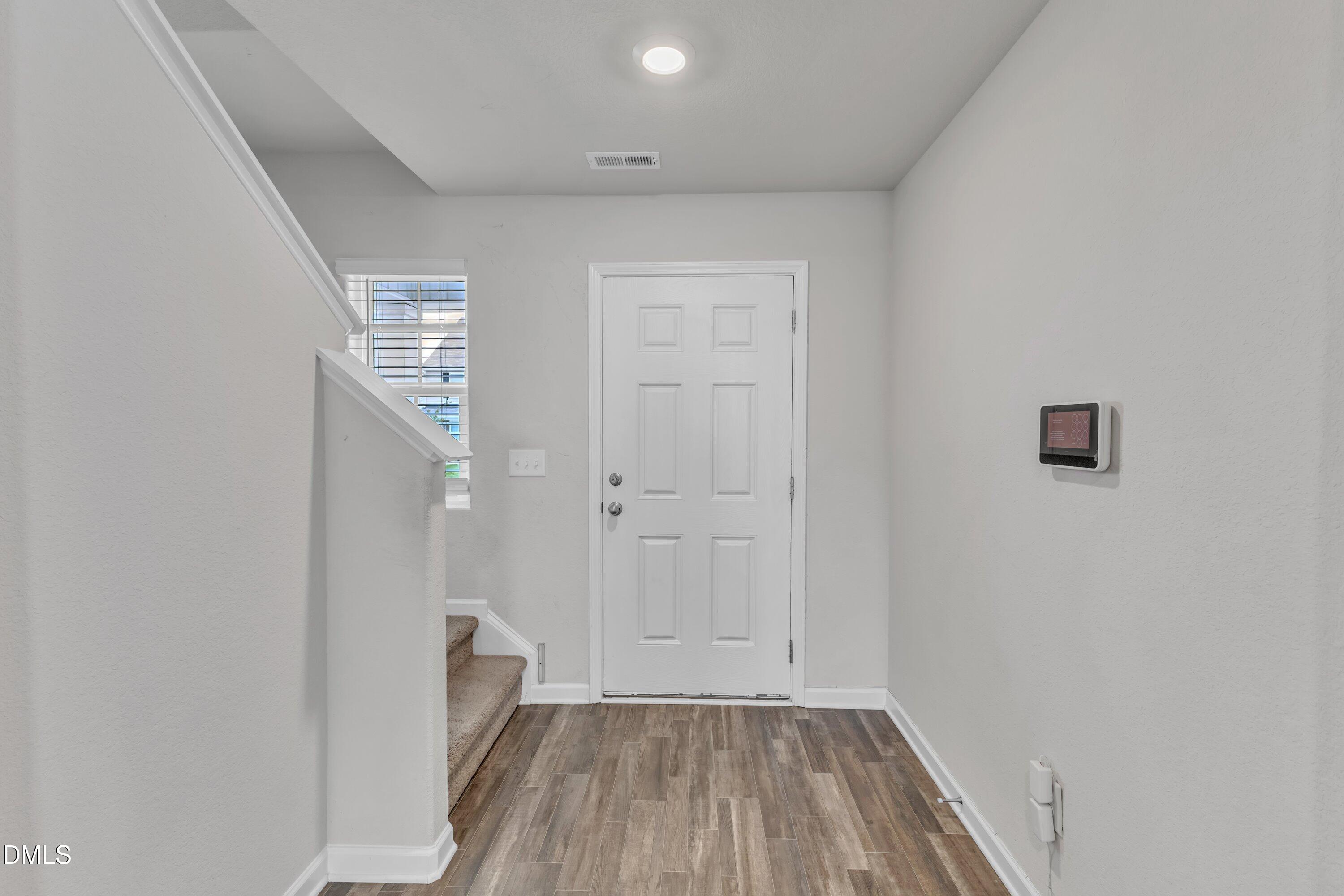 717 Little Patch Street Zebulon, NC 27597 - Photo 5 of 36 wooden floor in an empty room with a window