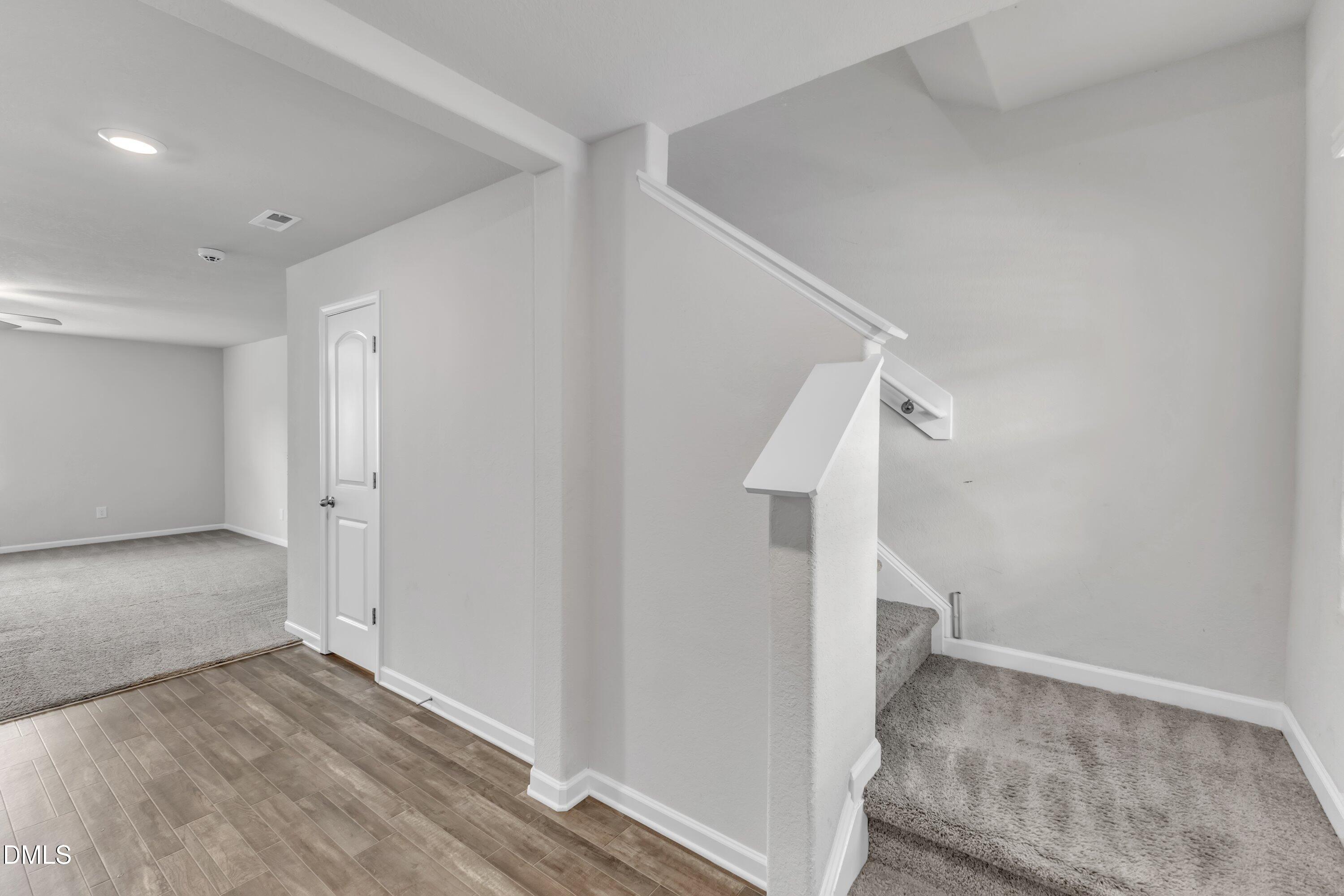 717 Little Patch Street Zebulon, NC 27597 - Photo 6 of 36 a view of a hallway with wooden floor and entryway