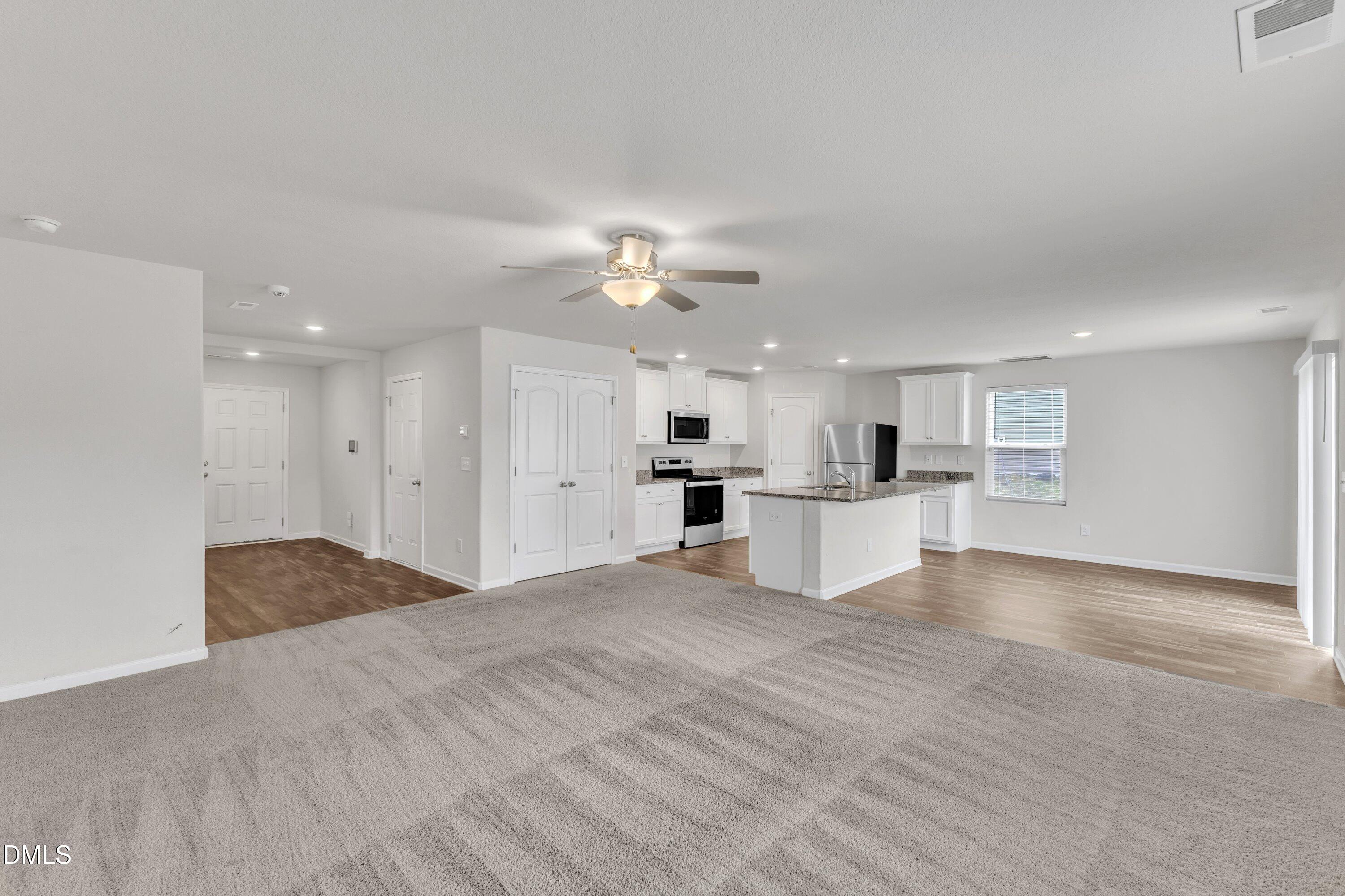 717 Little Patch Street Zebulon, NC 27597 - Photo 10 of 36 a view of a kitchen with kitchen island a sink stainless steel appliances and cabinets