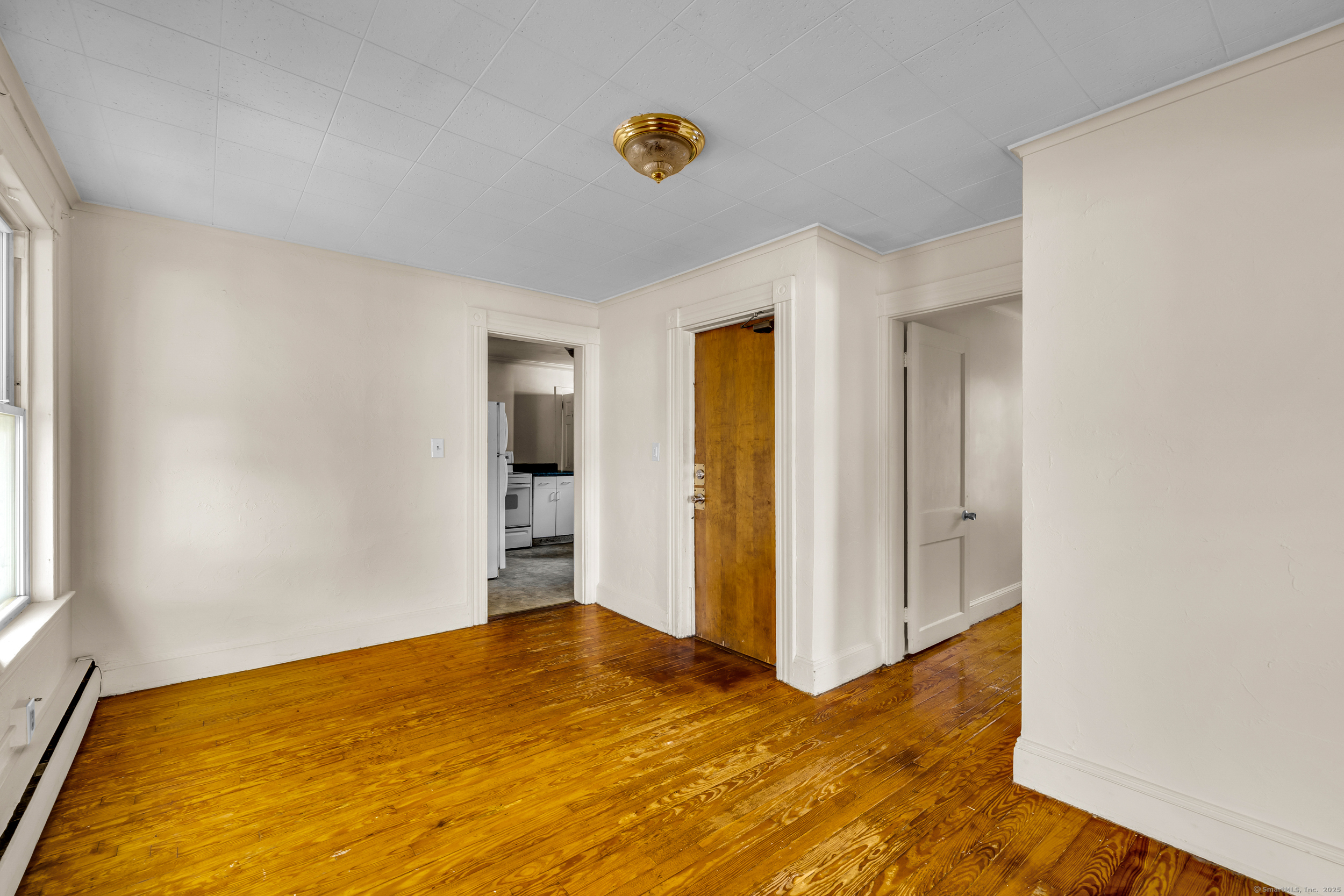 31 Wolcott Avenue, Unit 2 Torrington, CT 06790 - Photo 15 of 22 a view of empty room with wooden floor