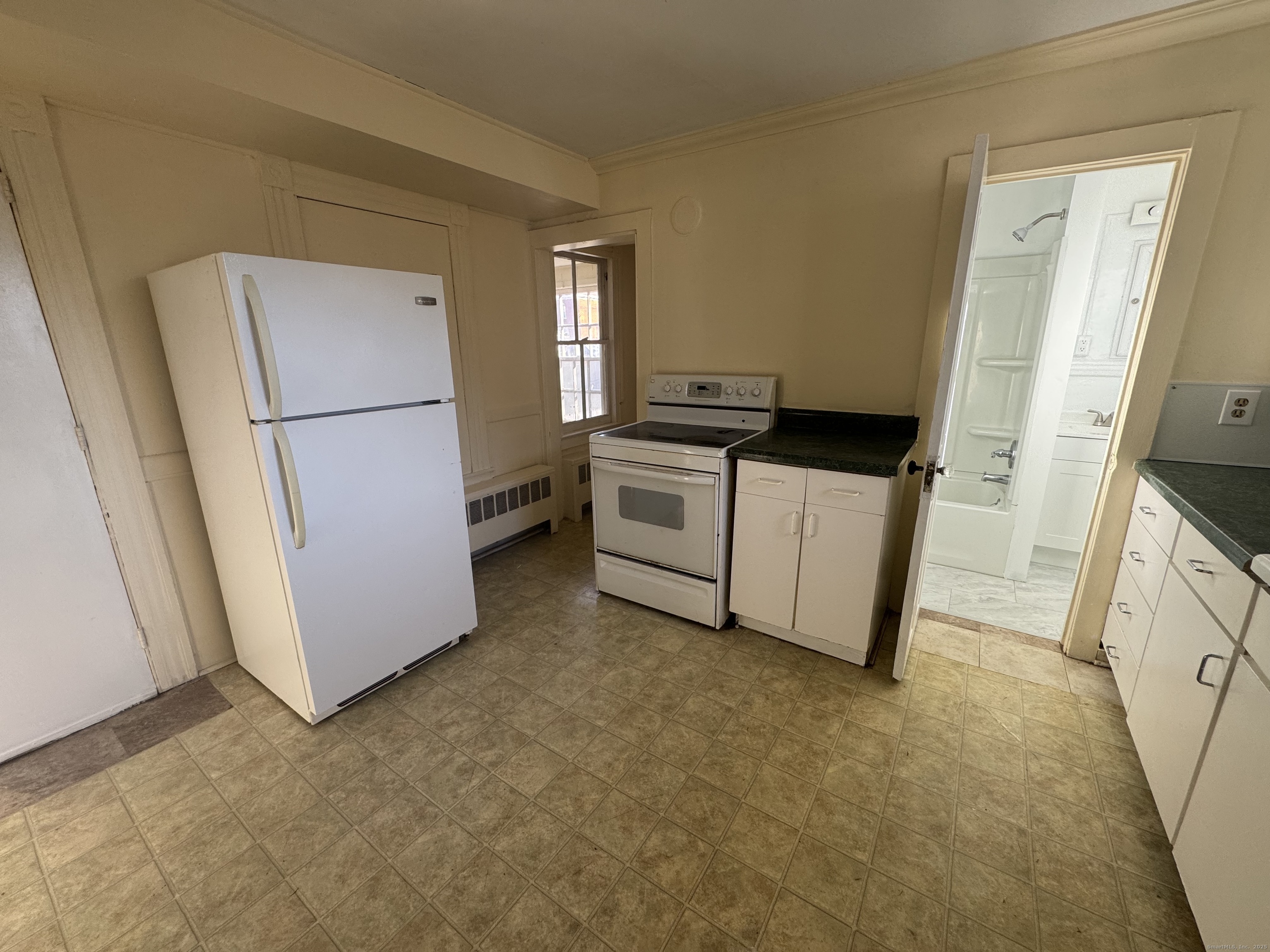 31 Wolcott Avenue, Unit 2 Torrington, CT 06790 - Photo 5 of 22 a kitchen with a refrigerator sink stove and cabinets