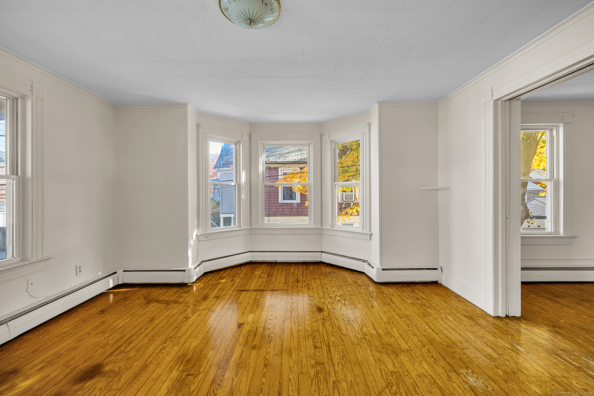 31 Wolcott Avenue, Unit 2 Torrington, CT 06790 - Photo 7 of 22 a view of an empty room with window and wooden floor