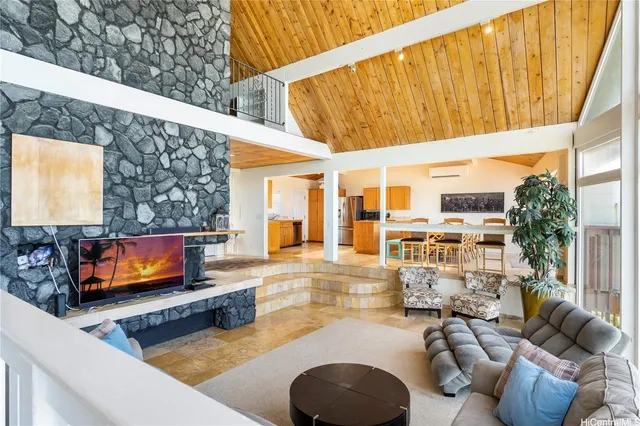 a view of a balcony with wooden floor and outdoor seating